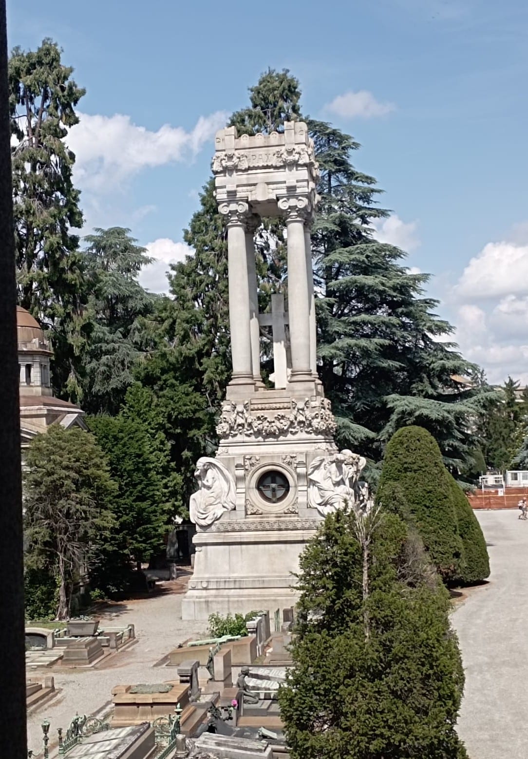 A monumental columned tomb among the cypresses at the Verano cemetery.