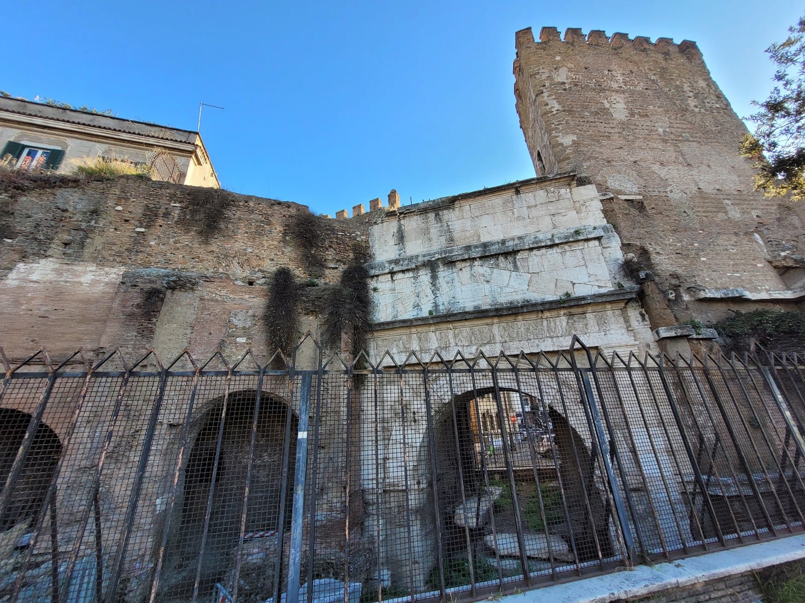 The layered ancient brickwork of the Porta Tiburtina gate.
