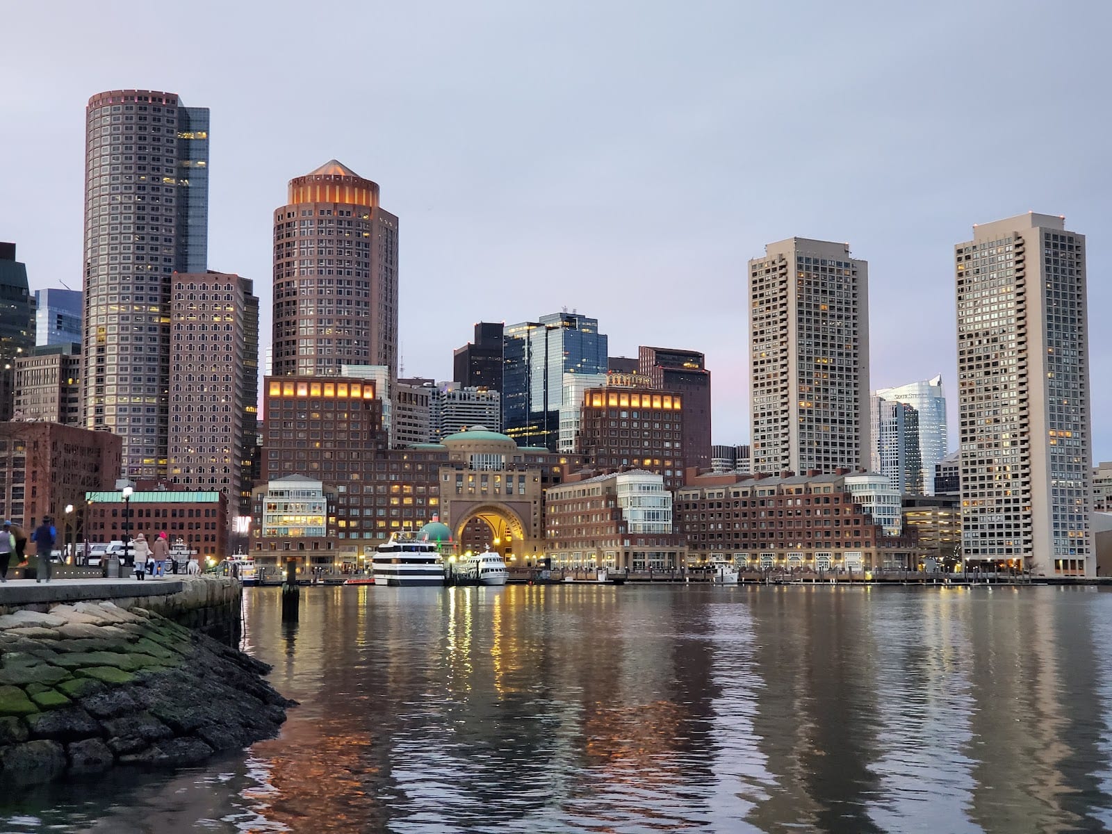 Boston Seaport waterfront with modern buildings and harbor views.