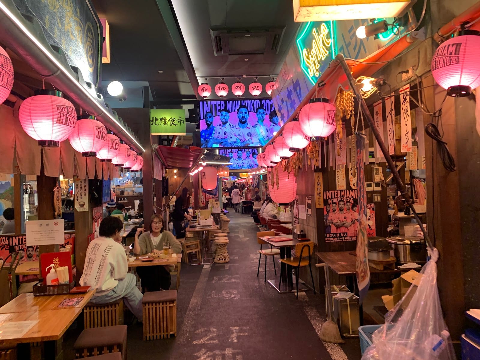 Stalls and diners at the open-air food alley at Miyashita Park.