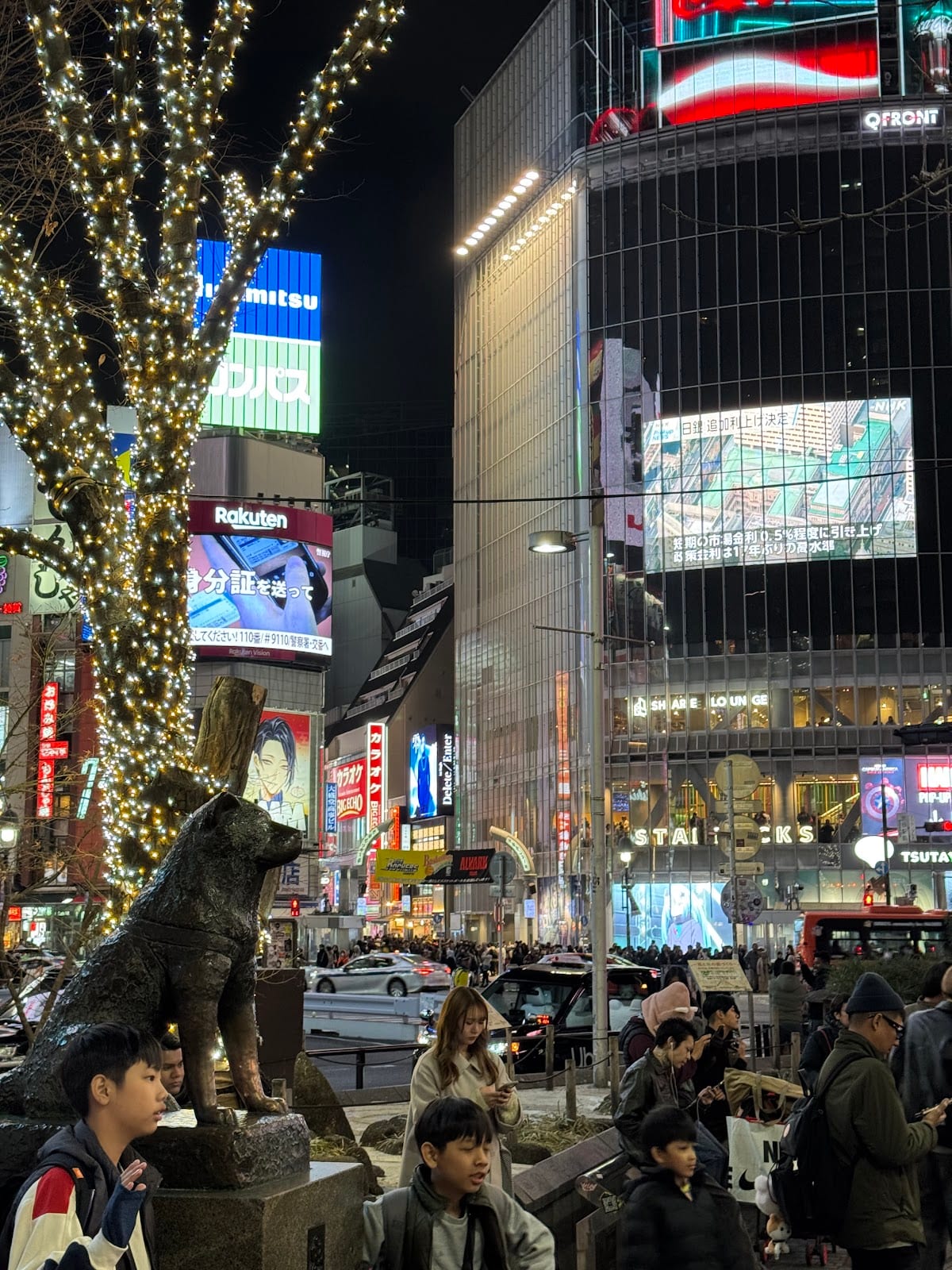 The Shibuya crossing lit up beneath winter illuminations.