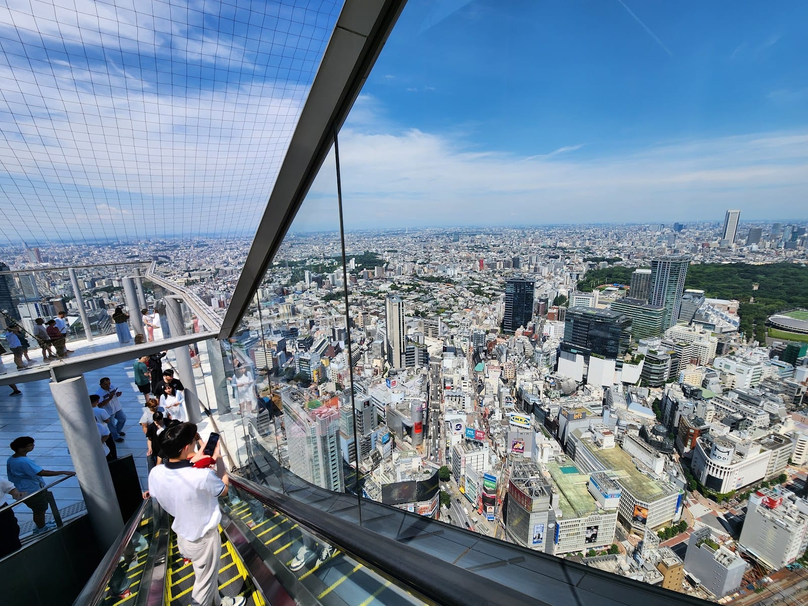 Shibuya Sky's edge and the Tokyo skyline beyond.