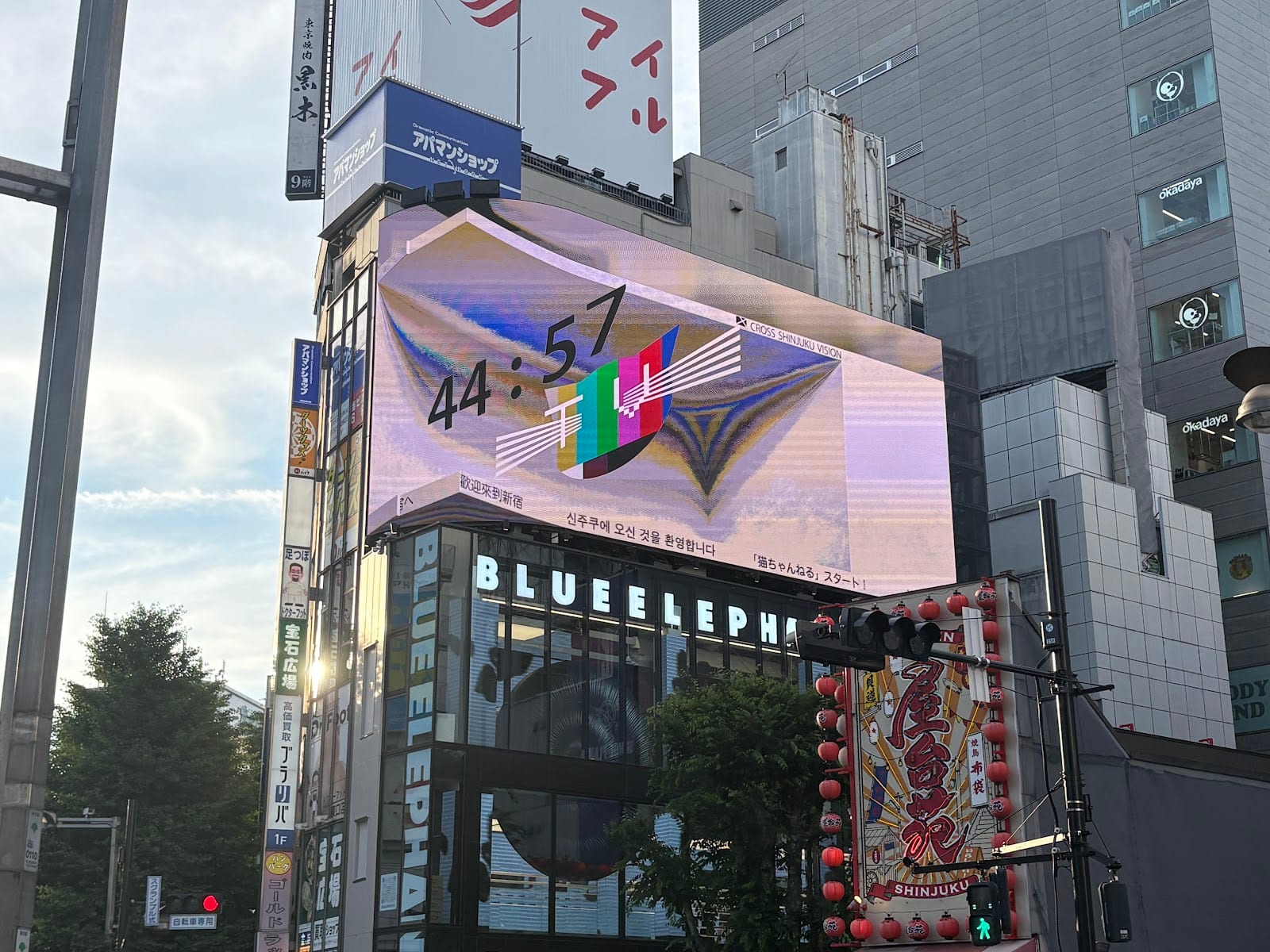 The Cross Shinjuku Vision screen wrapping the building corner above the East exit.