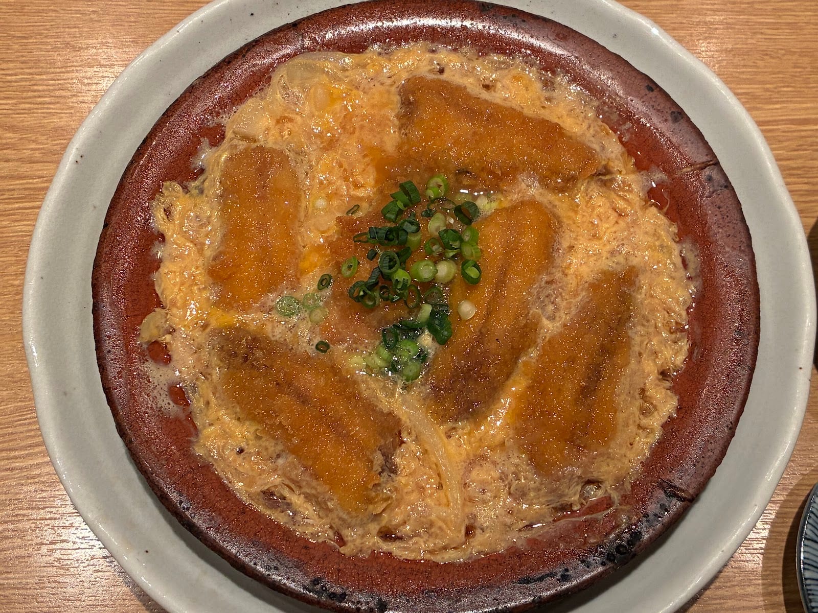 Nakajima's sardines simmered with egg in a clay pot.