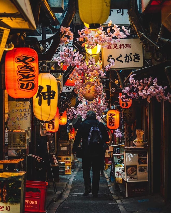 Red lanterns and signboards in the Omoide Yokocho alley.