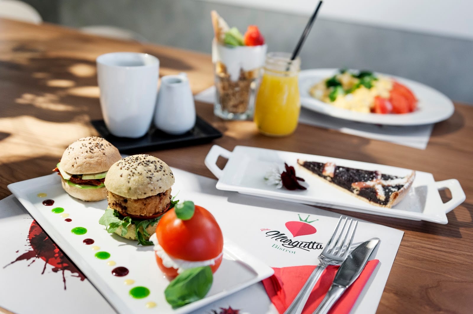 A spread of vegetarian dishes on branded plates at Il Margutta.