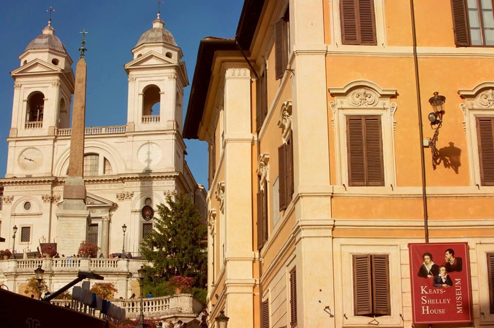 The Keats-Shelley House beside the Spanish Steps, with its banner and Trinita dei Monti behind.