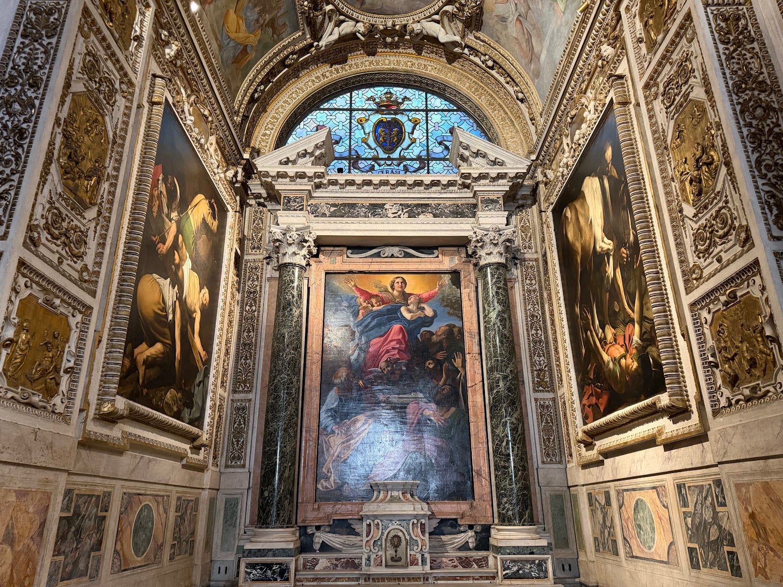The Cerasi Chapel with two Caravaggio paintings flanking Carracci's altarpiece.