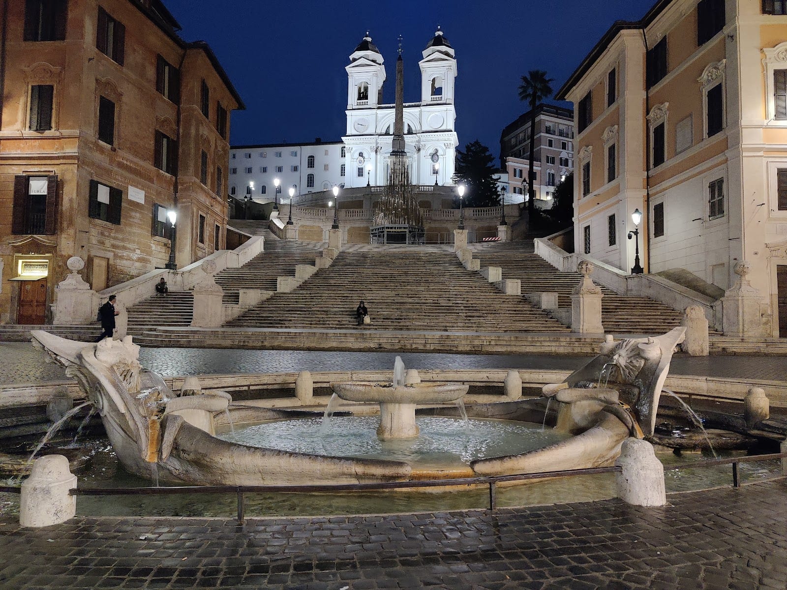 The Spanish Steps and the Barcaccia fountain at dusk.