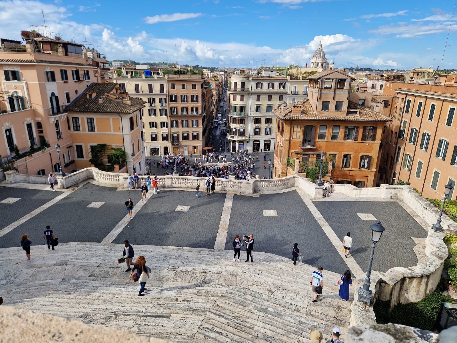 A wide daytime view over Piazza di Spagna and the staircase.