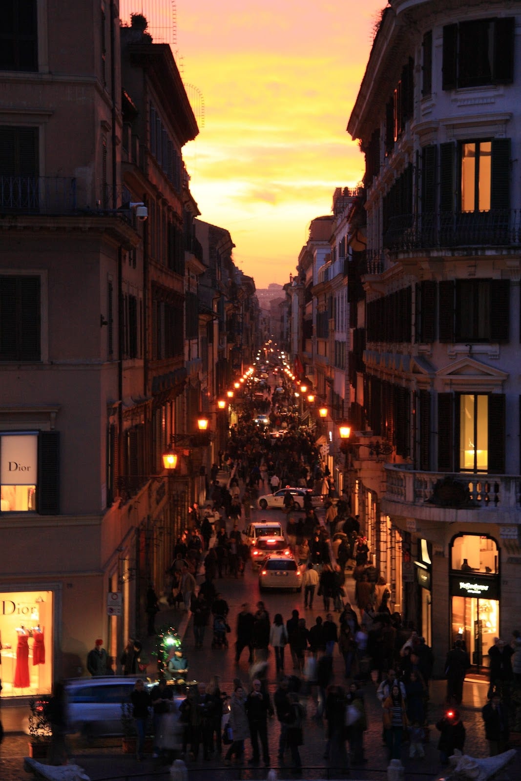 The shopping street glittering with lights at dusk.