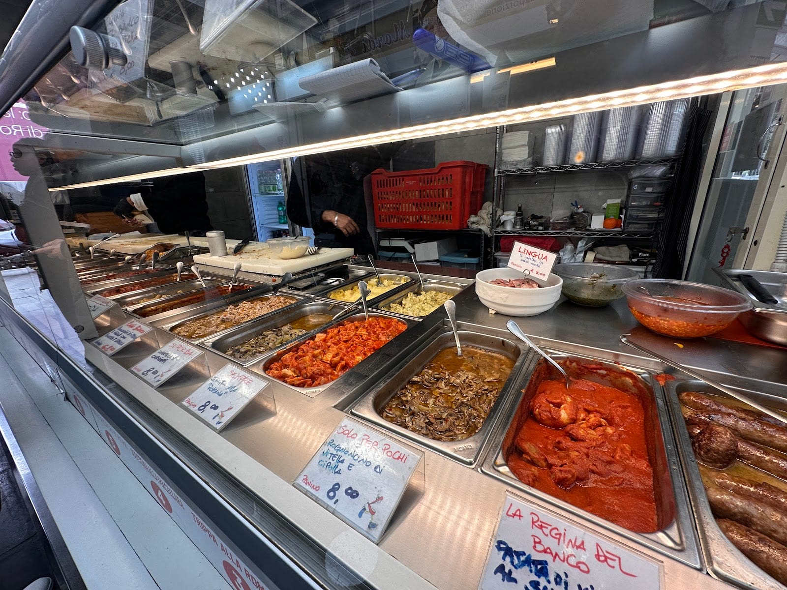 Trays of slow-cooked Roman stews at the Mordi e Vai counter.
