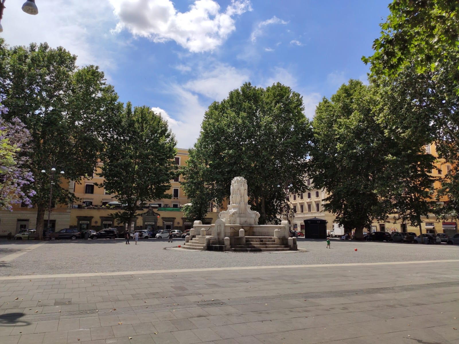 The open, tree-lined Piazza Testaccio with its fountain at the center.