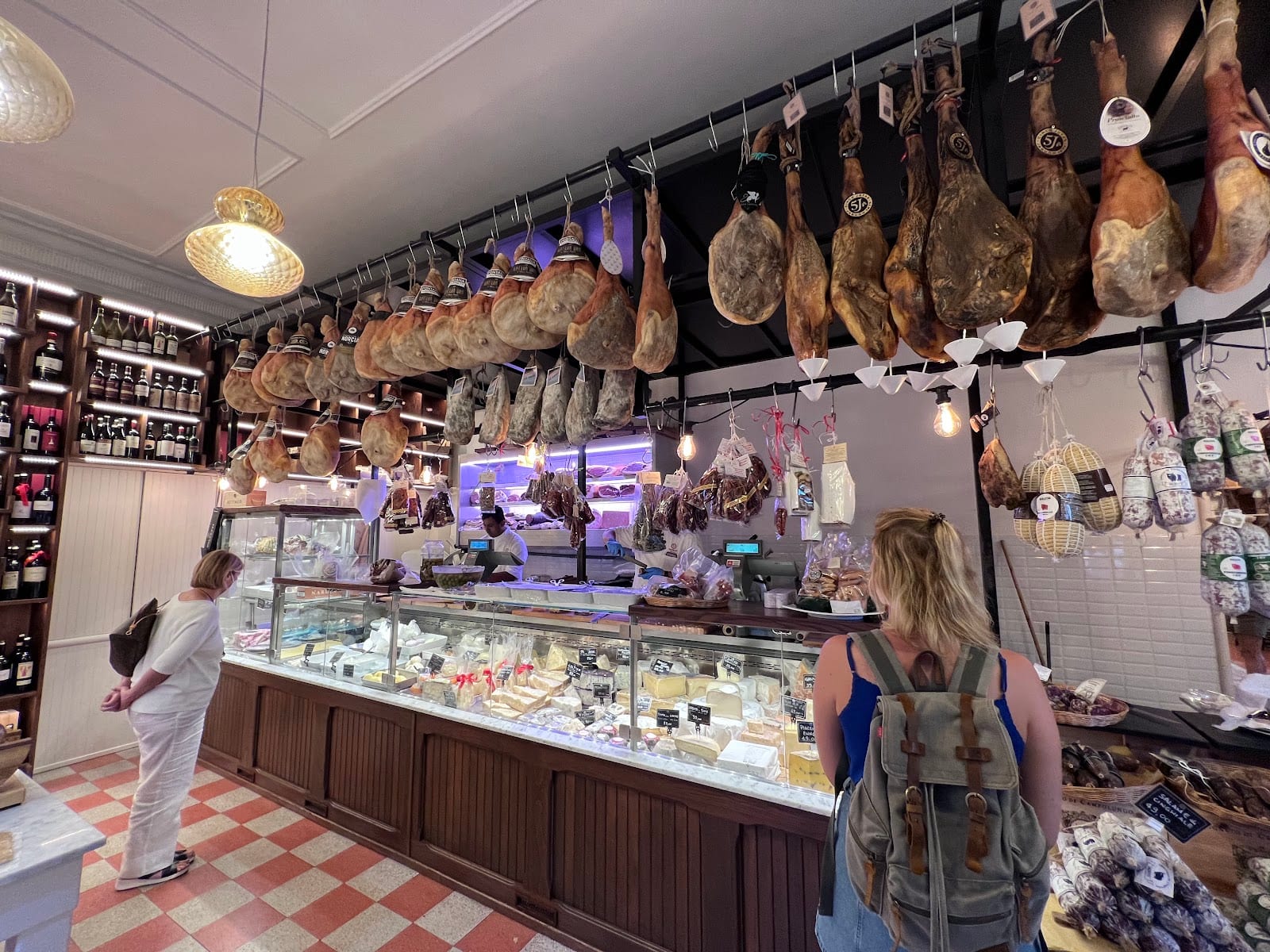Customers browsing the cured meats and cheeses inside Volpetti.