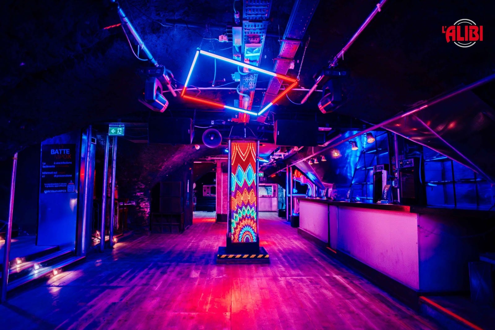 The neon-lit dance floor of the Alibi club under Monte Testaccio.