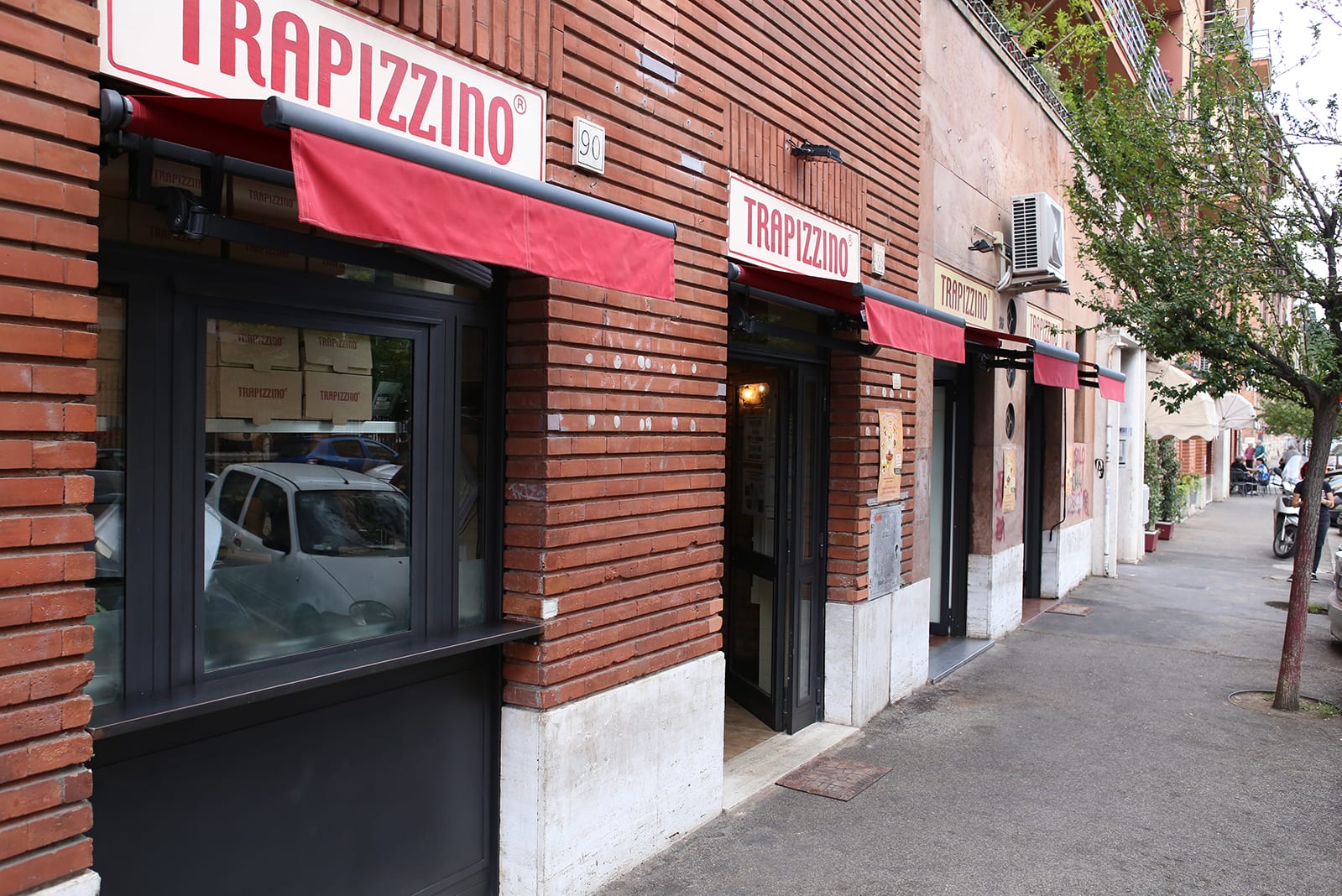 The Trapizzino shopfront on a brick building in Testaccio.