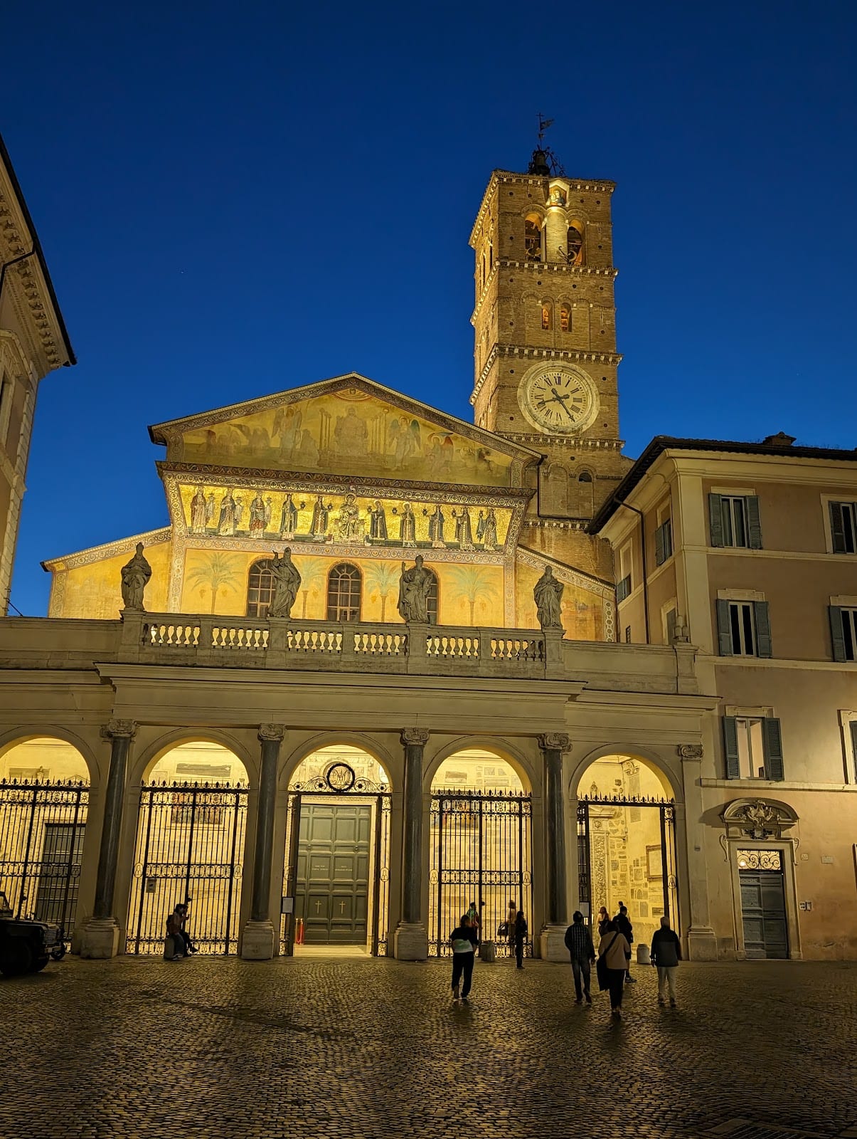 The medieval mosaic facade and bell tower of Santa Maria in Trastevere.
