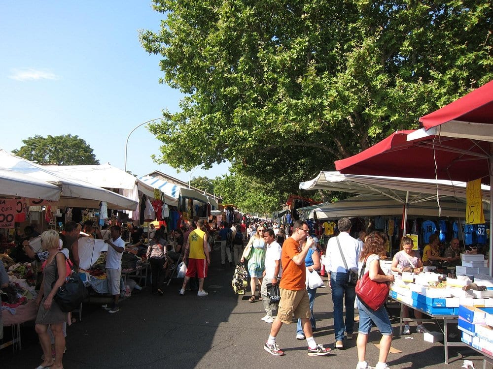 The Porta Portese flea market stretching down a tree-lined street on a Sunday.