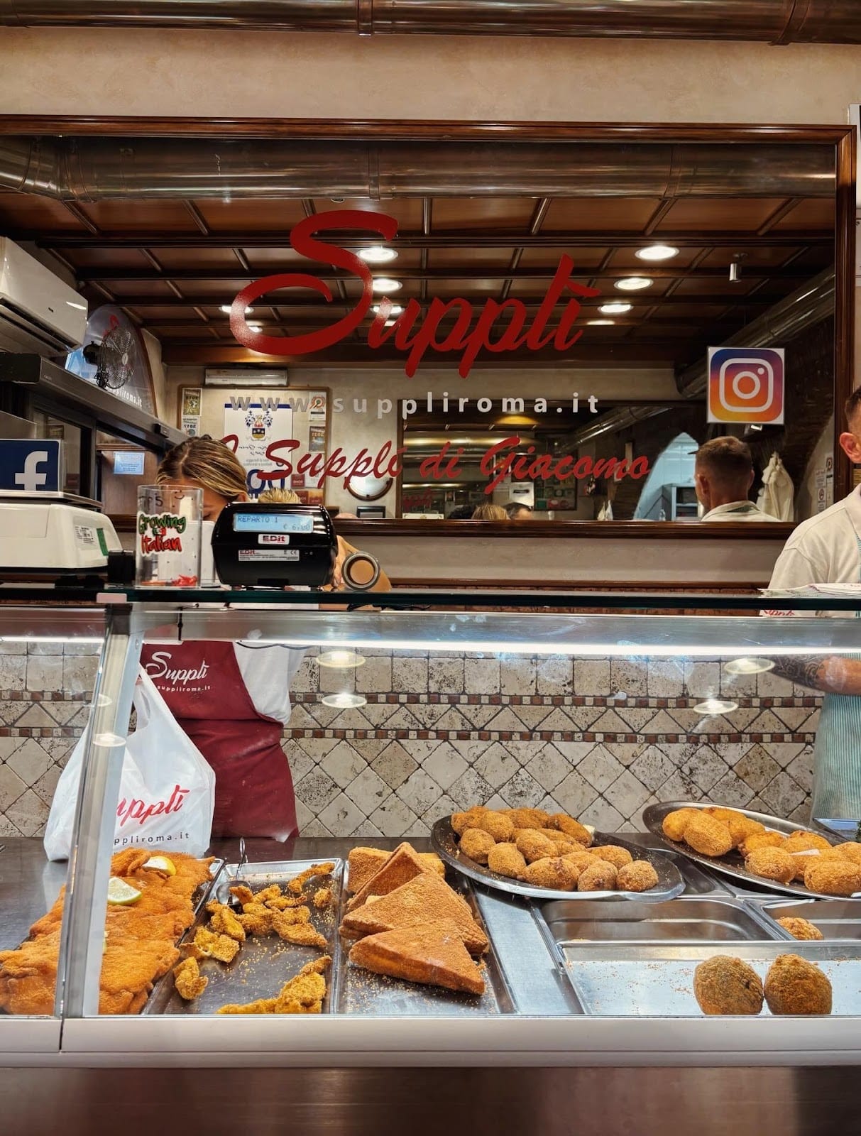 The counter and sign of Supplì Roma in Trastevere.