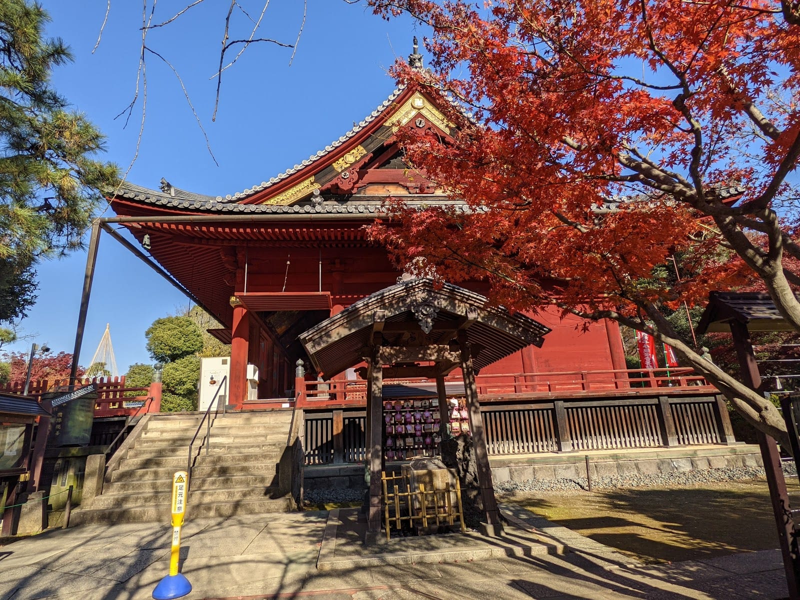 The red hall of Kiyomizu Kannon-do among autumn maples.