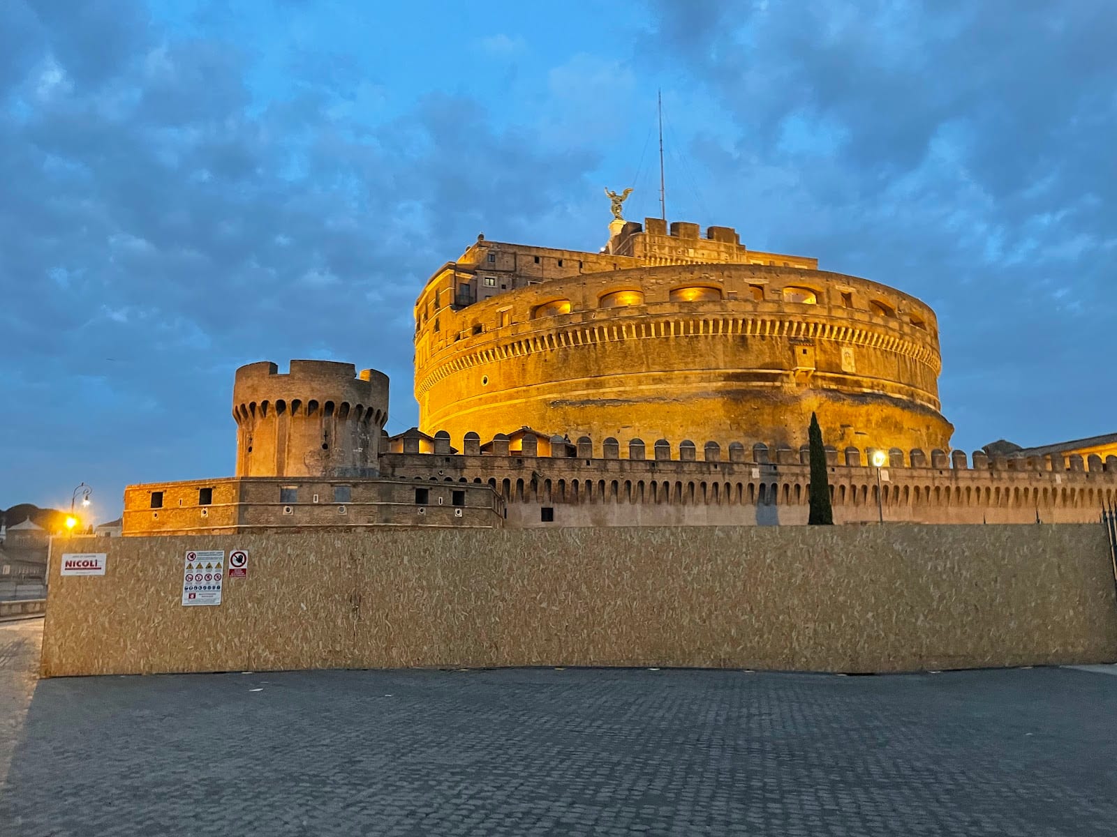 The floodlit drum of Castel Sant'Angelo at dusk.
