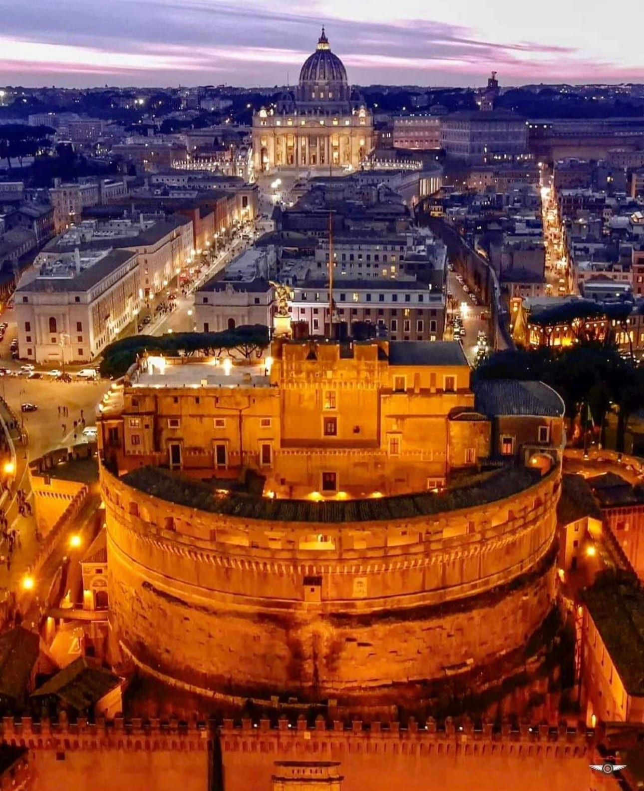 An aerial night view of Castel Sant'Angelo in Rome.