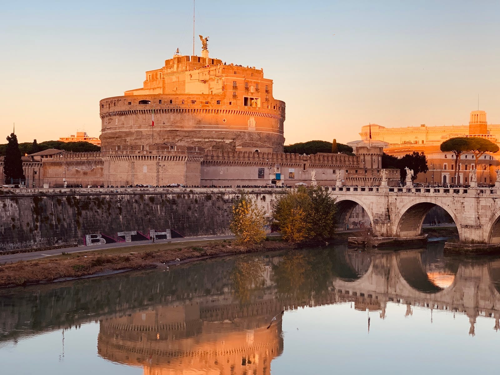 Castel Sant'Angelo and the Ponte Sant'Angelo over the Tiber at golden hour.