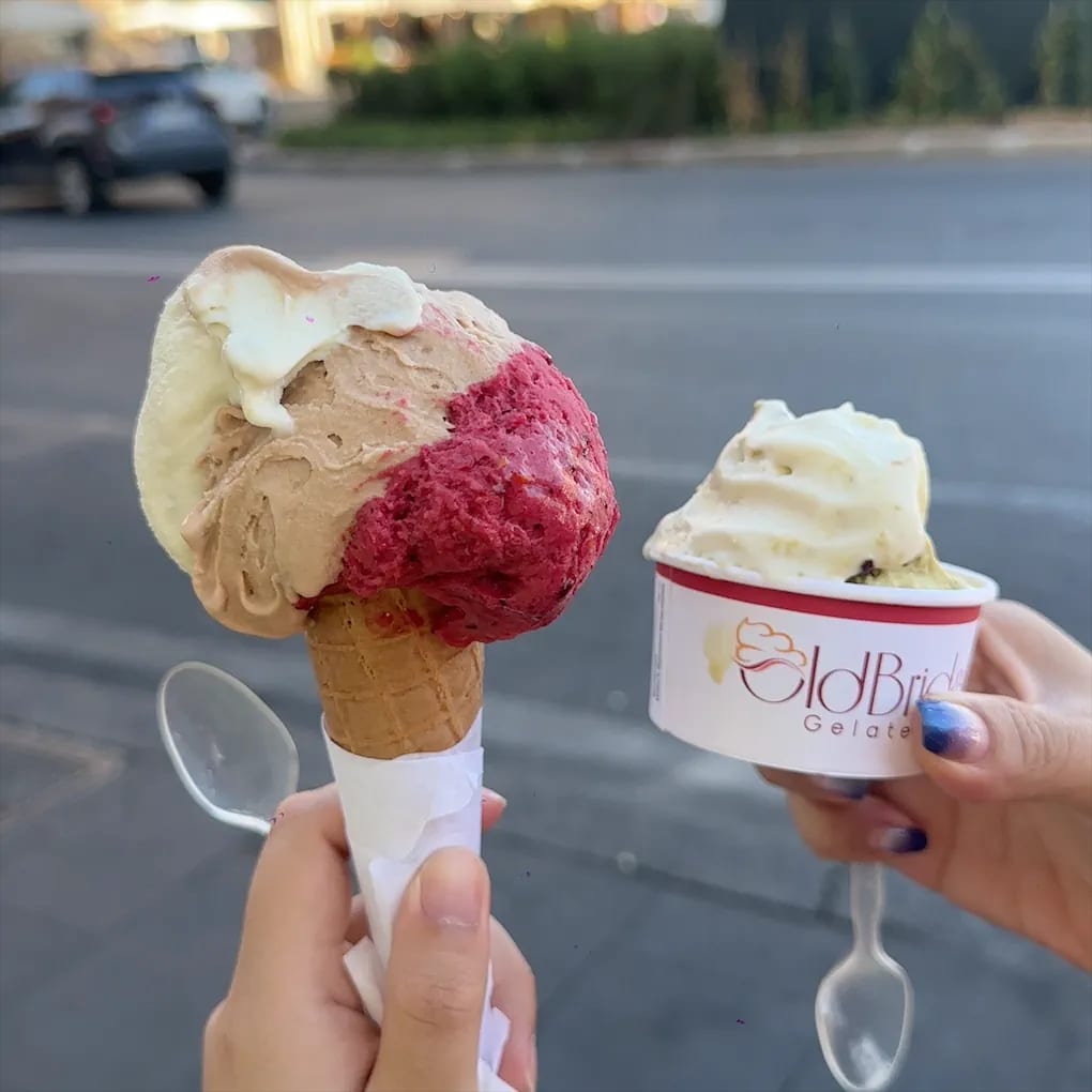 A cone and a cup of gelato from Old Bridge Gelateria.