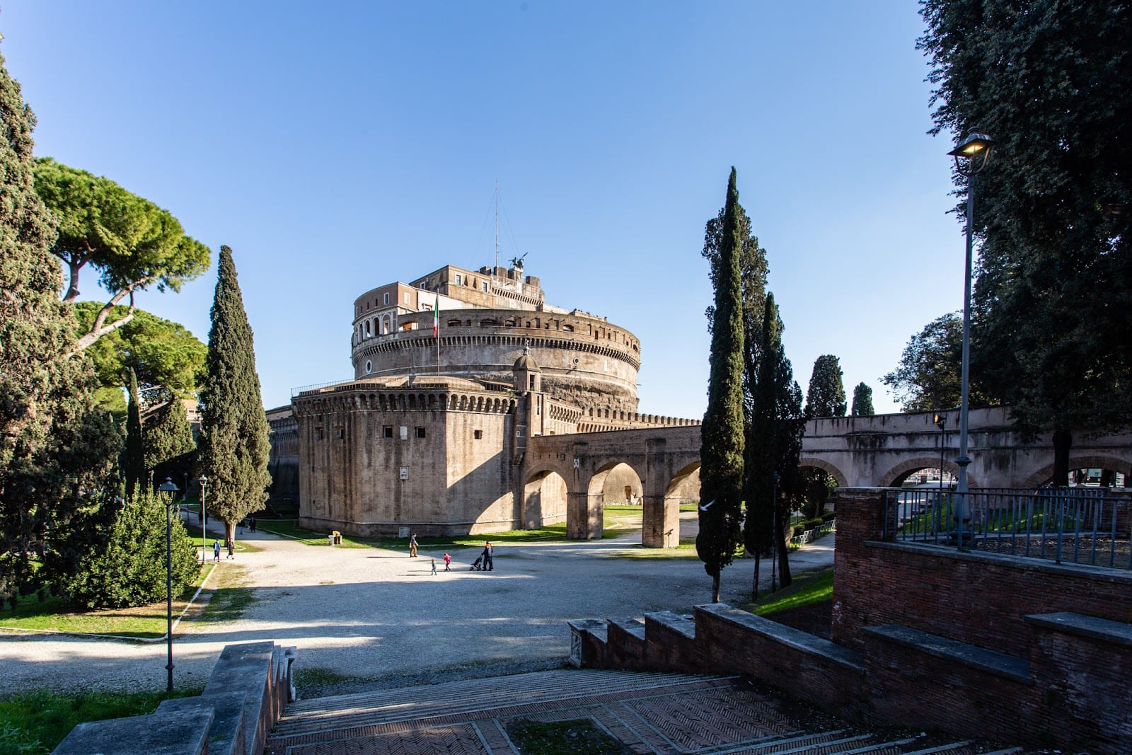 The Passetto di Borgo arches running toward Castel Sant'Angelo, framed by umbrella pines.