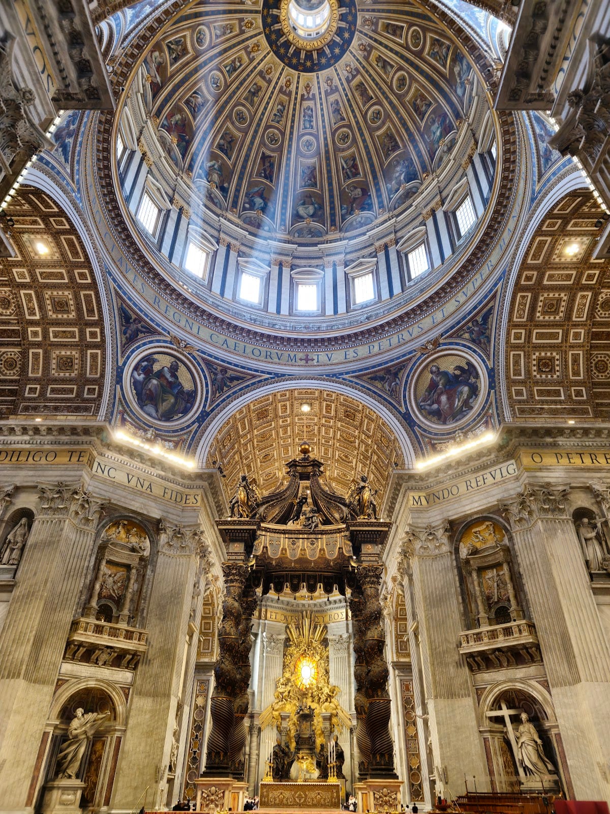 The interior of St Peter's Basilica with Bernini's bronze baldachin beneath the dome.