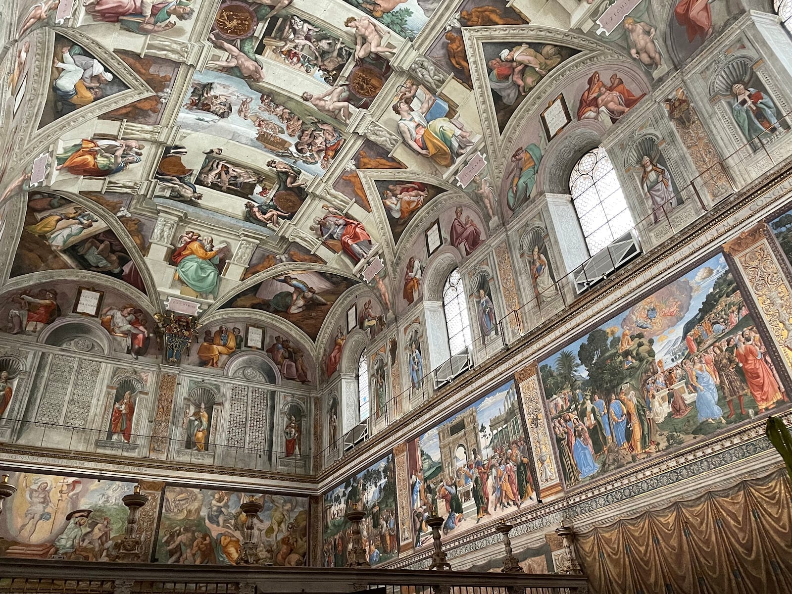 Michelangelo's frescoed ceiling and walls in the Sistine Chapel.