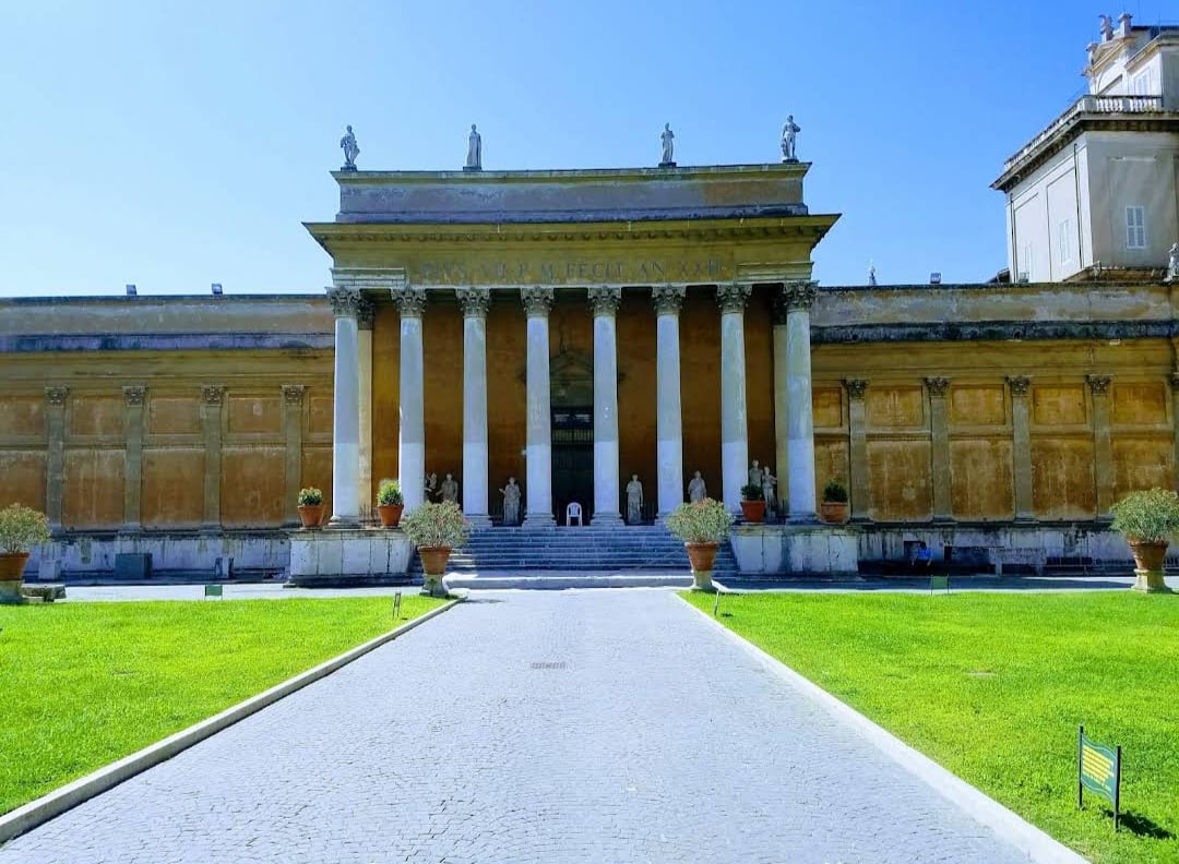 The colonnaded facade of the Pinacoteca building at the Vatican Museums.