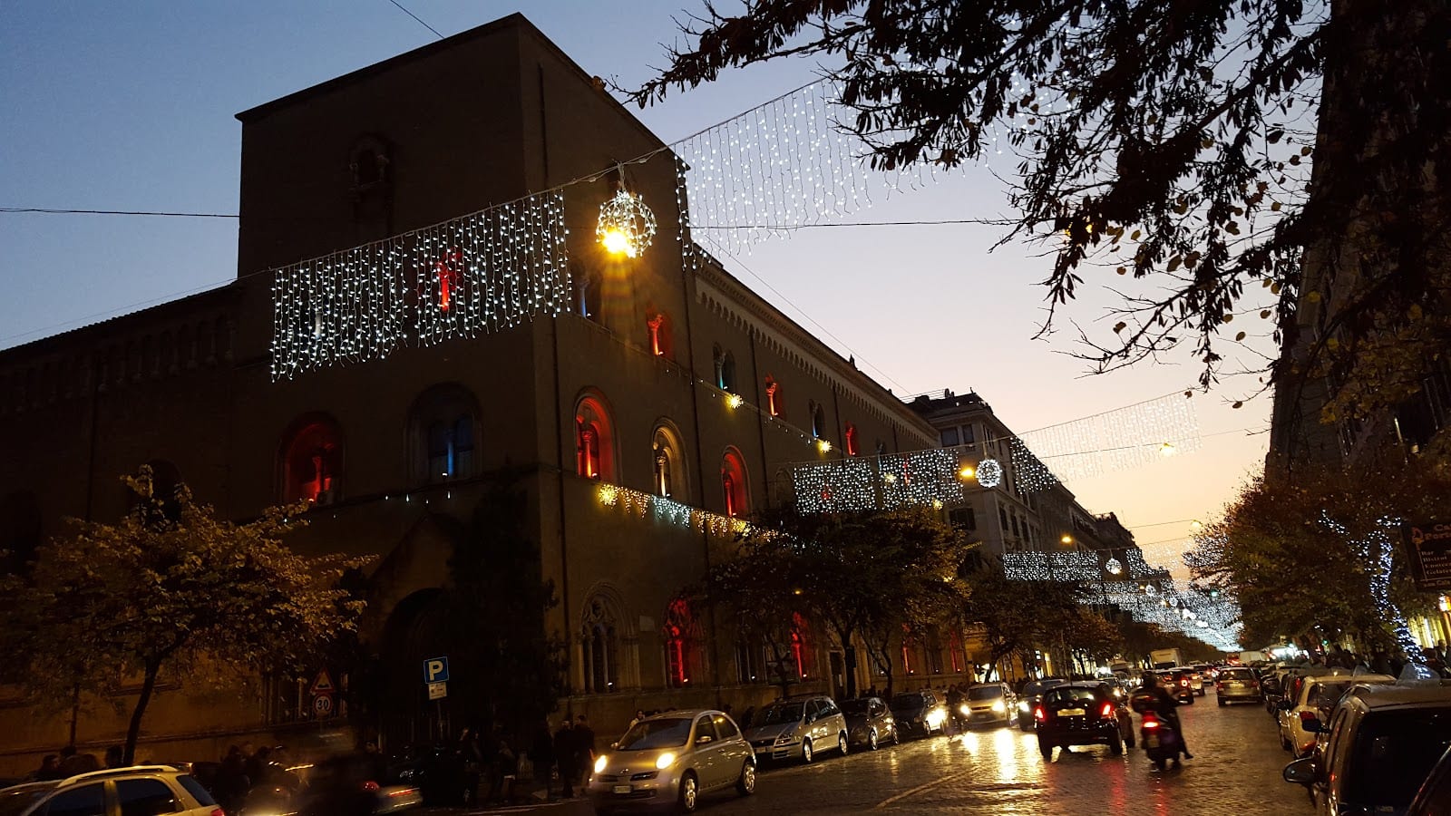 The COIN Excelsior department store on Via Cola di Rienzo lit up at dusk.