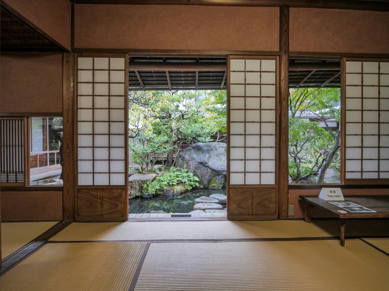 A tatami room opening onto the courtyard pond at the Asakura Museum.