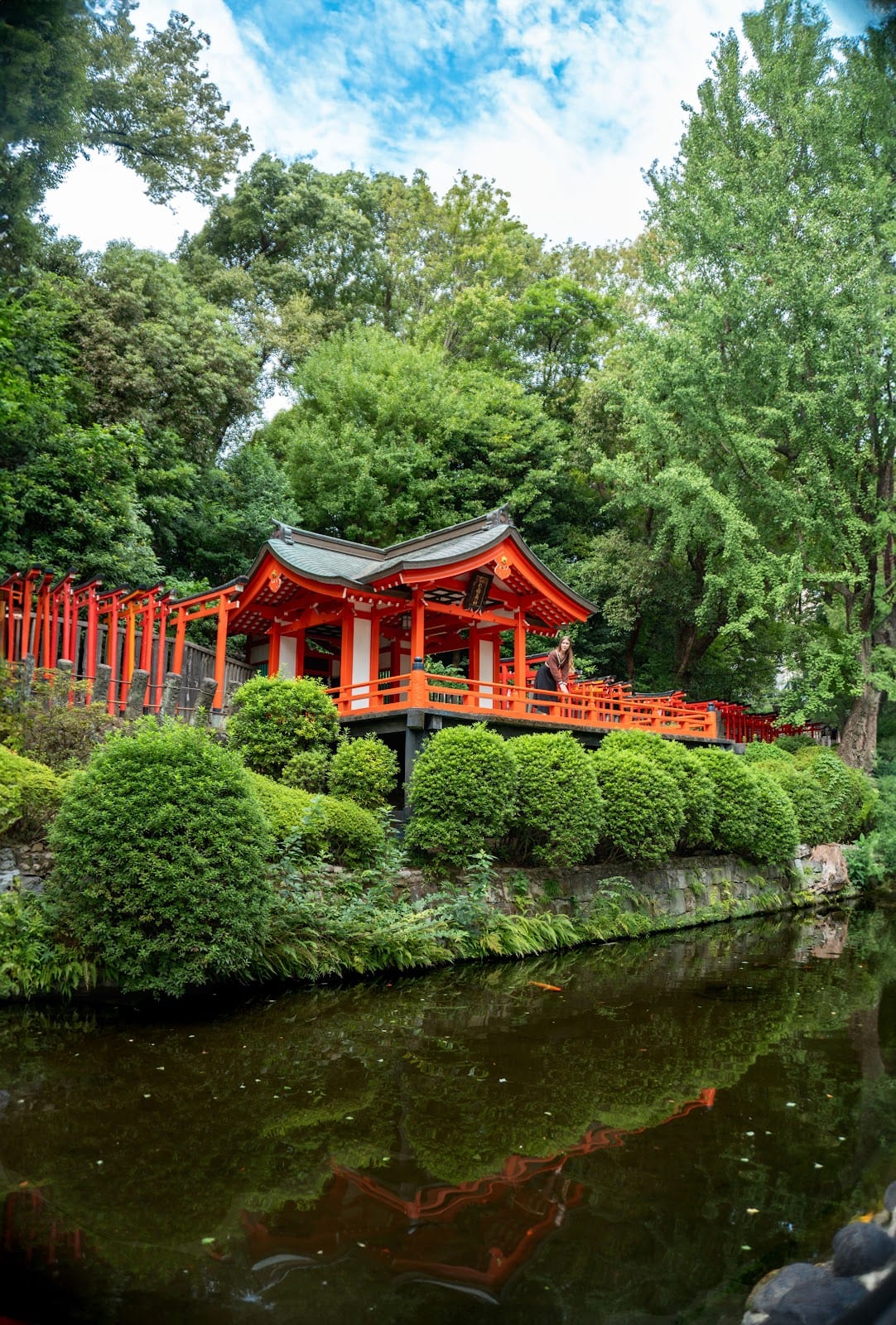 A vermilion pavilion above the pond in the grounds of Nezu Shrine.