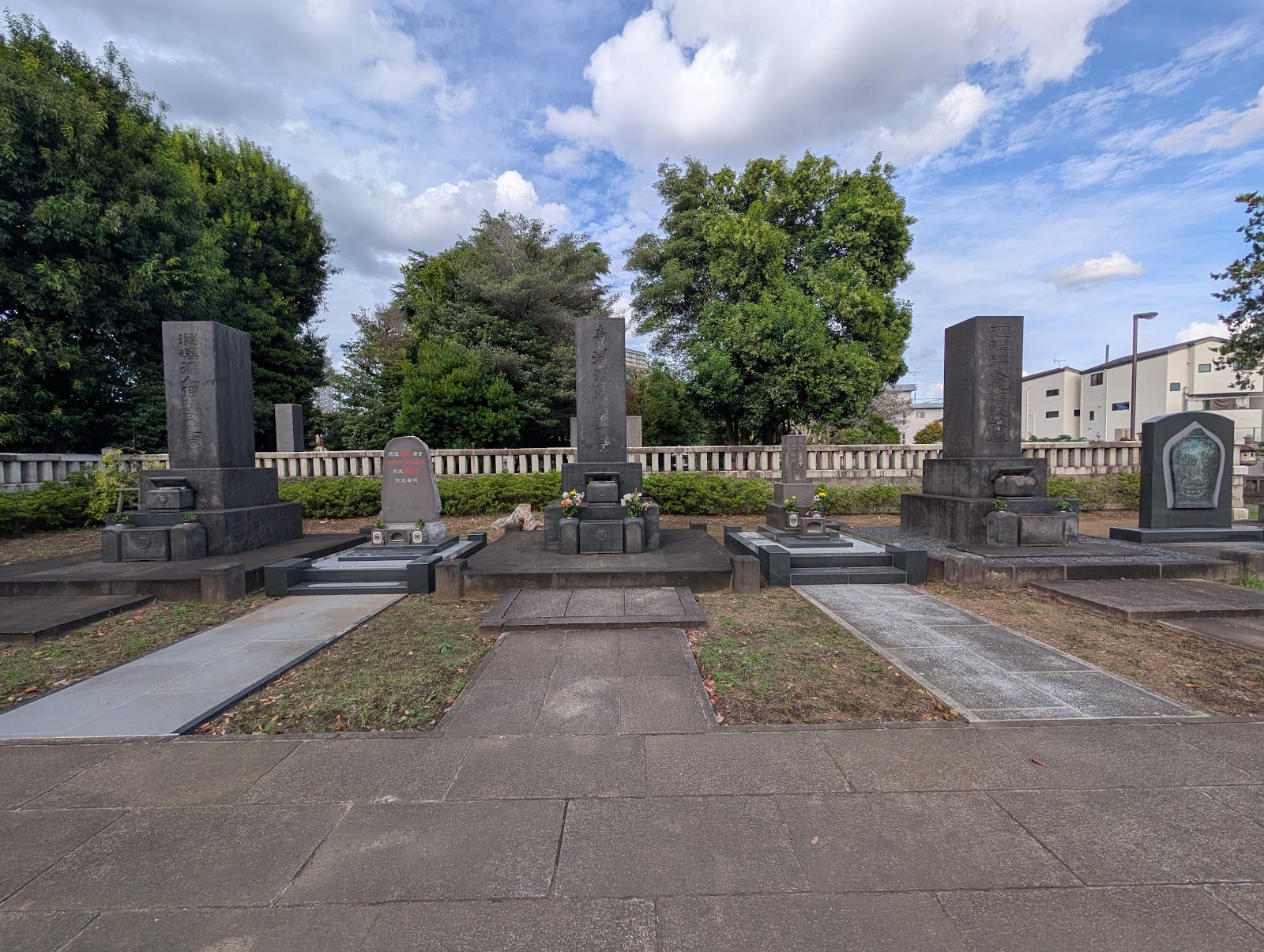 Rows of gravestones under open sky in Yanaka Cemetery.