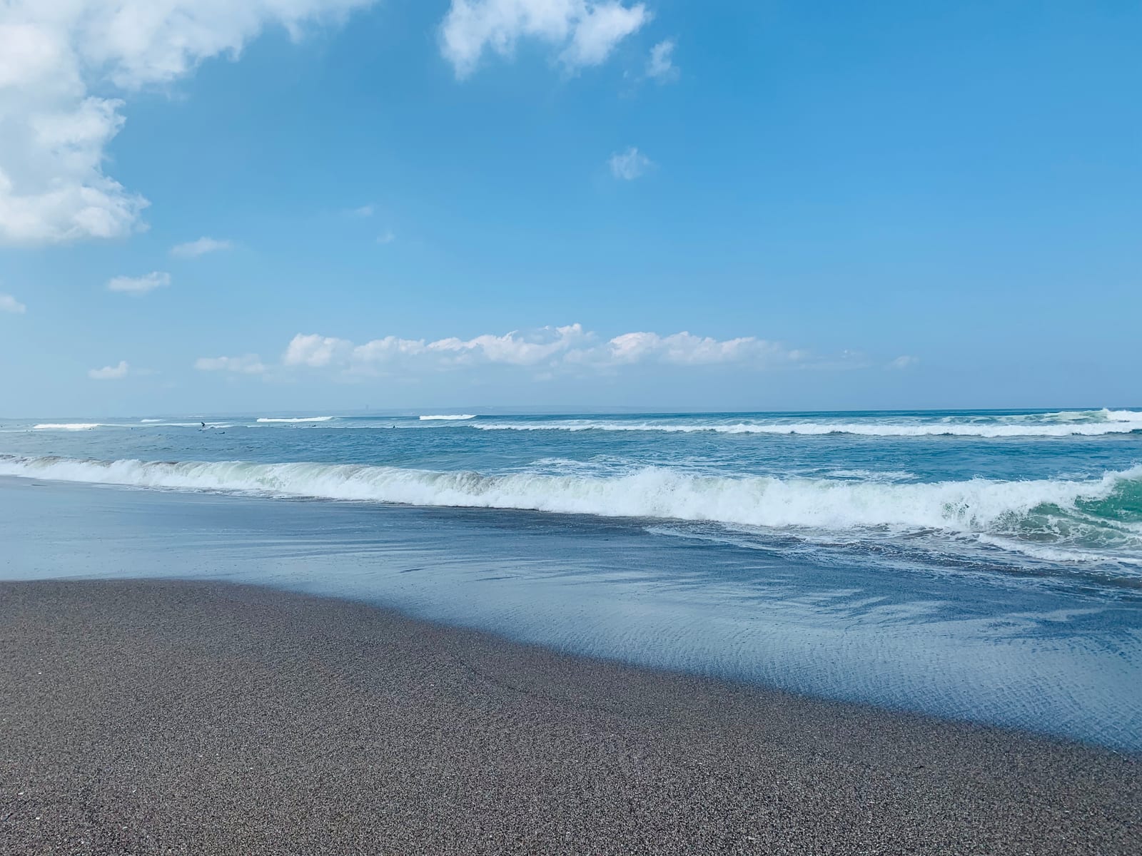 Waves break along the shoreline at Batu Bolong Beach in Canggu.