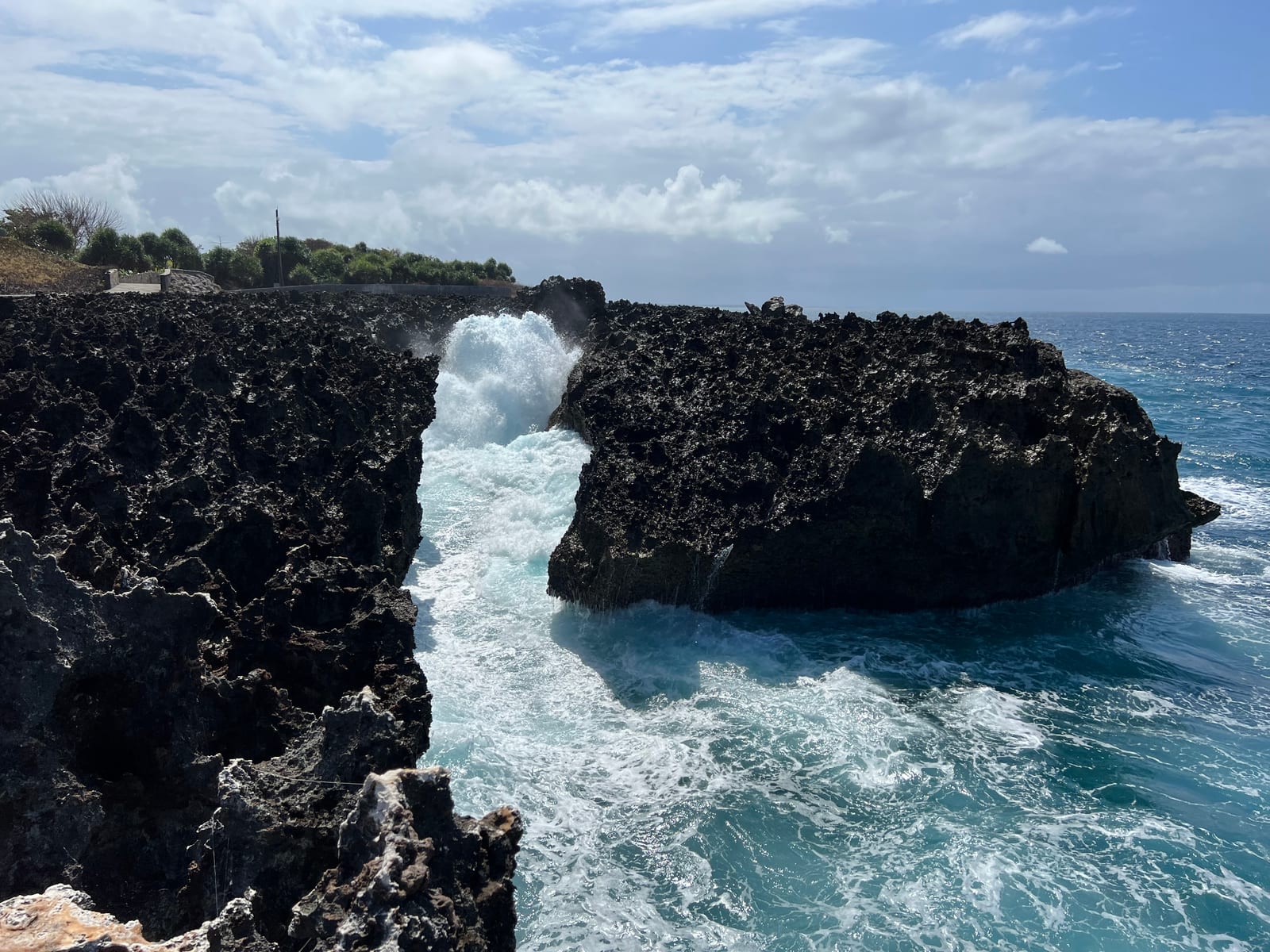 Seawater surges through a rocky opening at Water Blow on the Nusa Dua coast.
