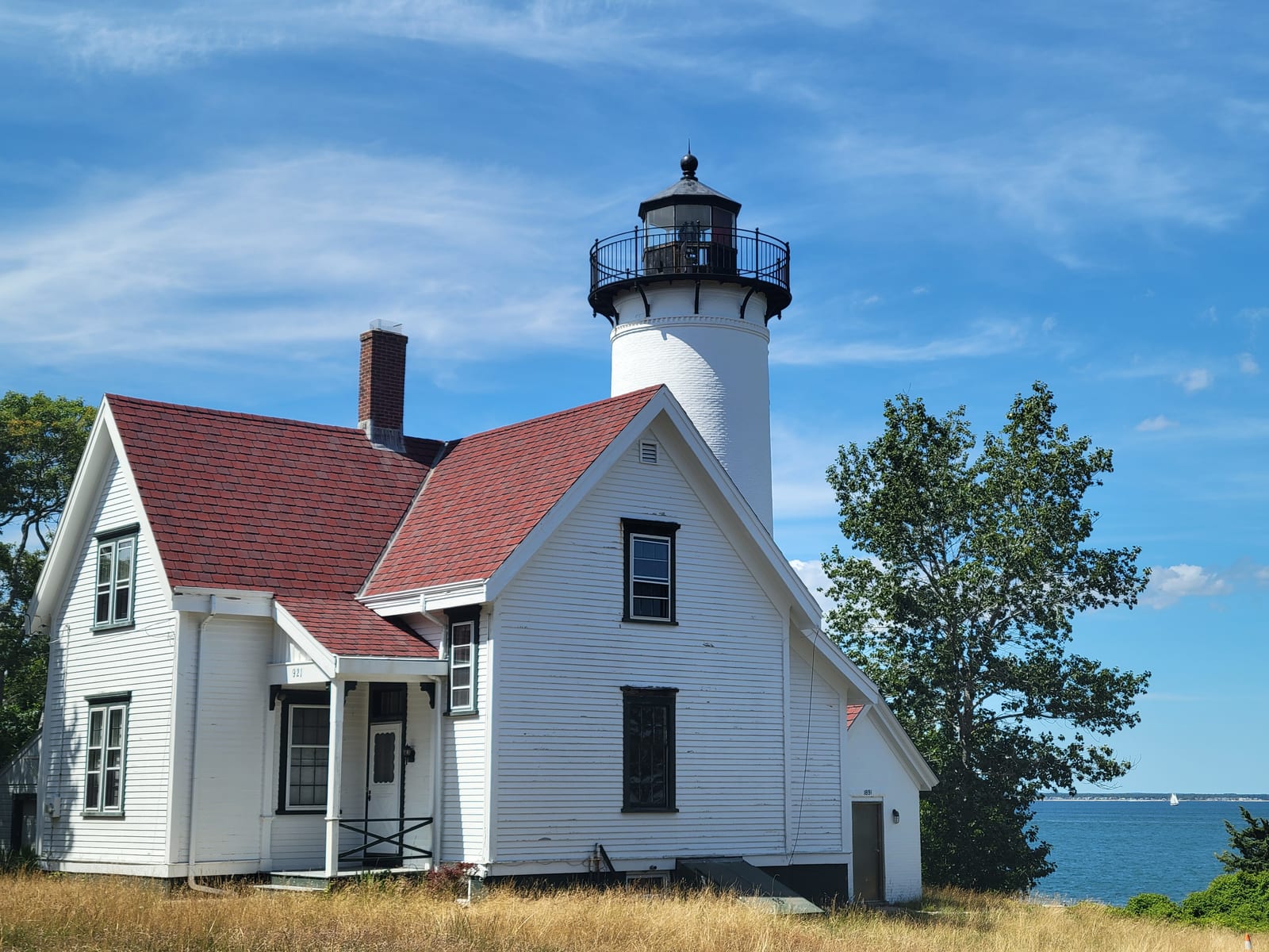 West Chop Lighthouse and its white keeper's house are shown under a blue sky.