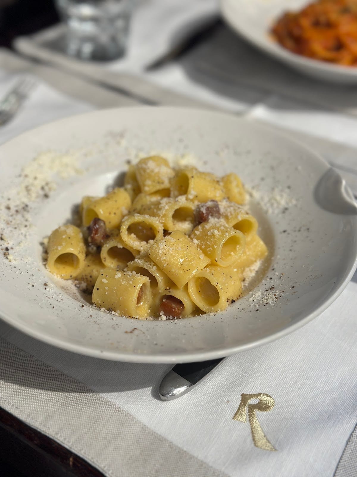 Roscioli's rigatoni carbonara with cubes of guanciale and cracked black pepper.