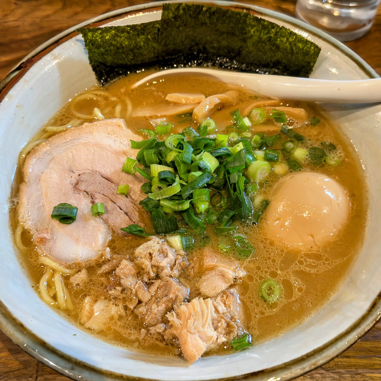 A bowl of rich Tokyo ramen with chashu pork, a soft egg and scallions at Fuunji in Shinjuku.