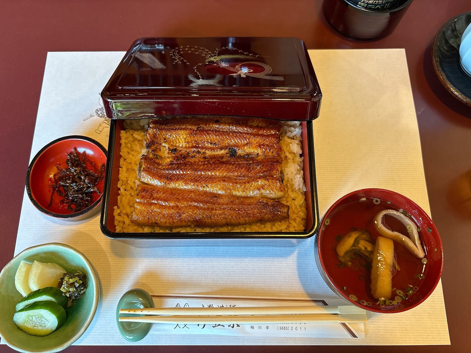 Grilled eel over rice in a lacquer box, served with soup and pickles at Izuei near Ueno.