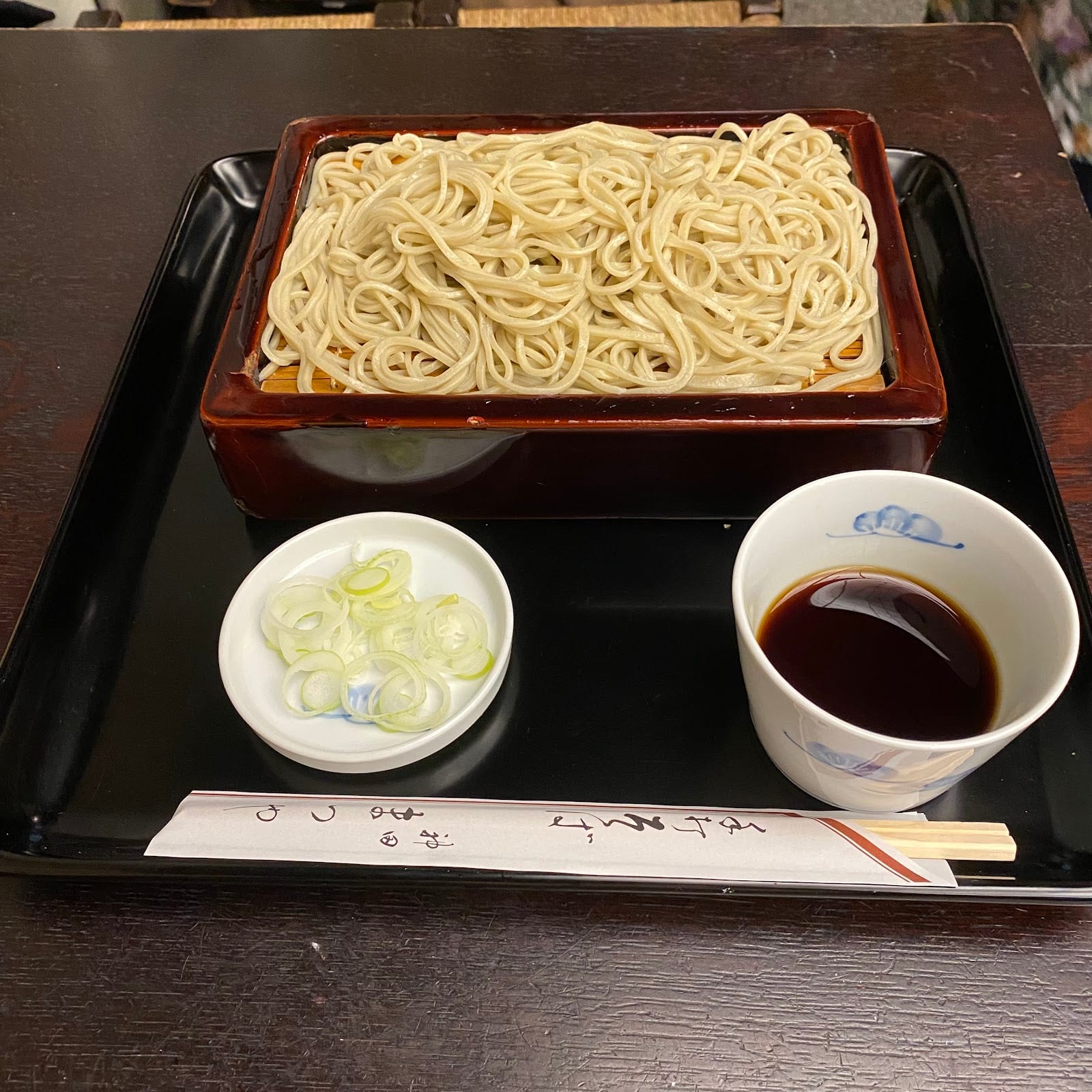Cold zaru soba on a bamboo tray with a dipping cup at Kanda Matsuya.
