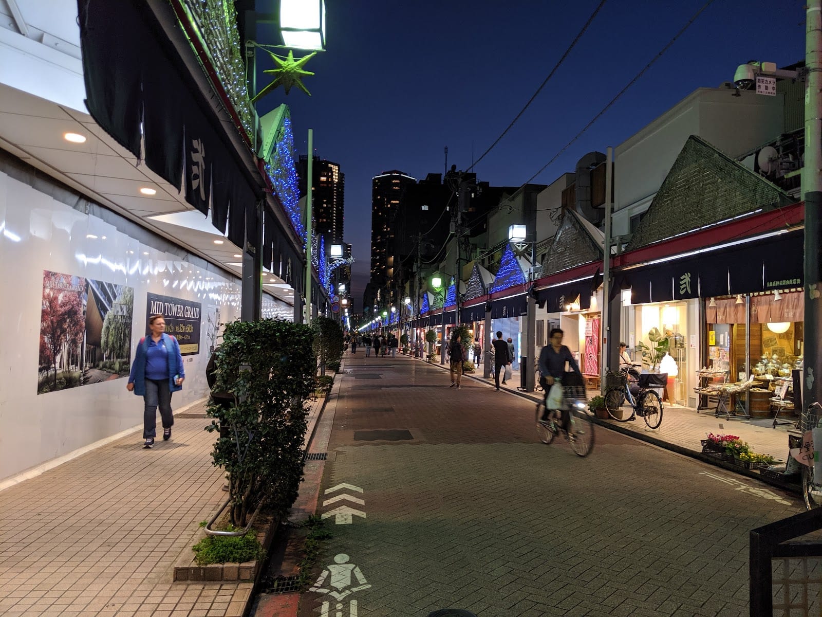 Tsukishima's Monja Street at dusk, its shops lit along the strip.