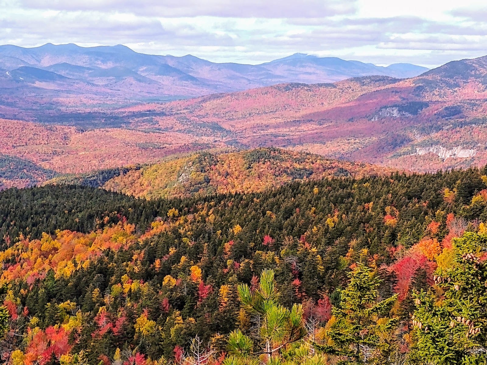 Brilliant autumn foliage along a mountain road in the White Mountains of New Hampshire.