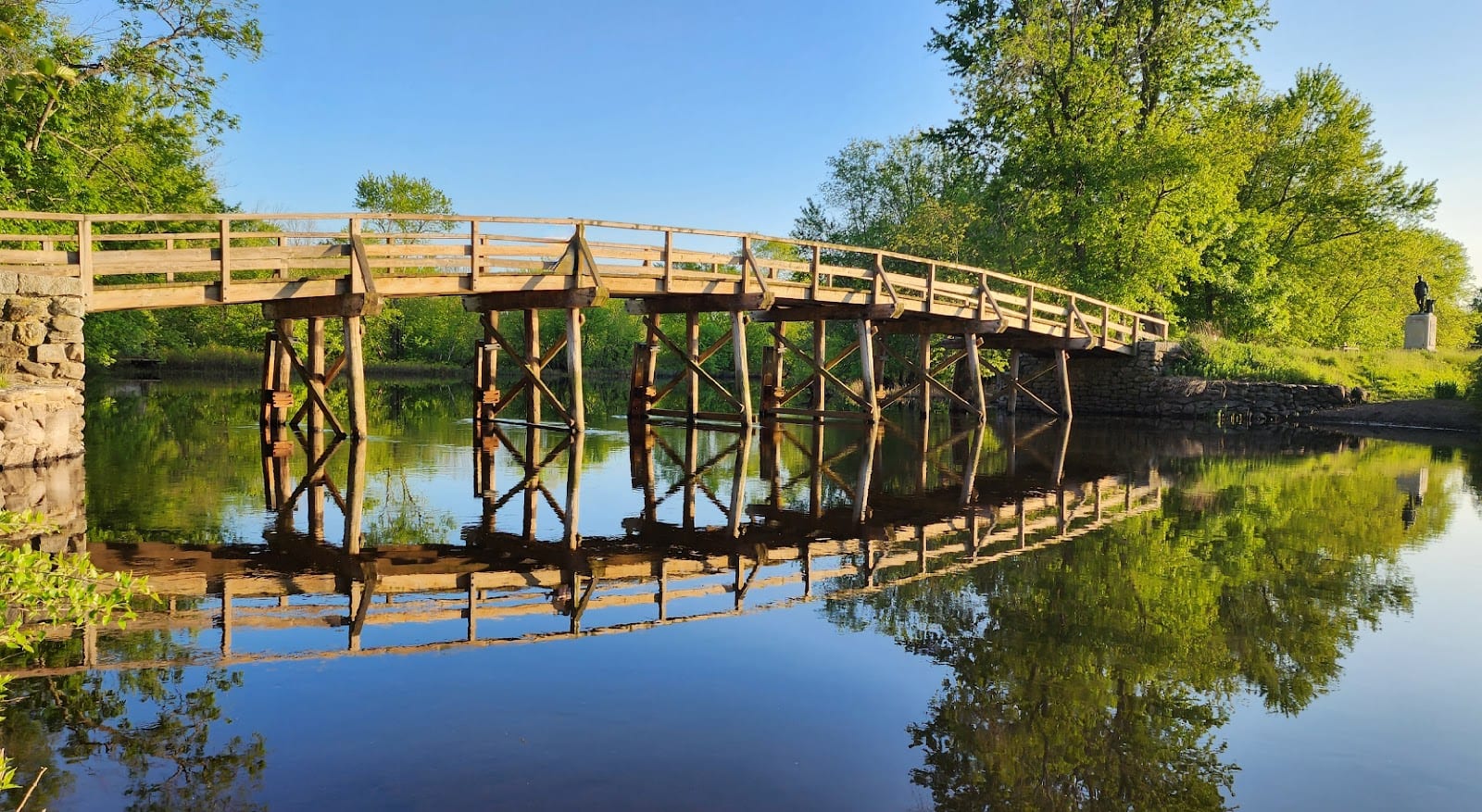 The Old North Bridge in Concord, Massachusetts, reflected in the Concord River.
