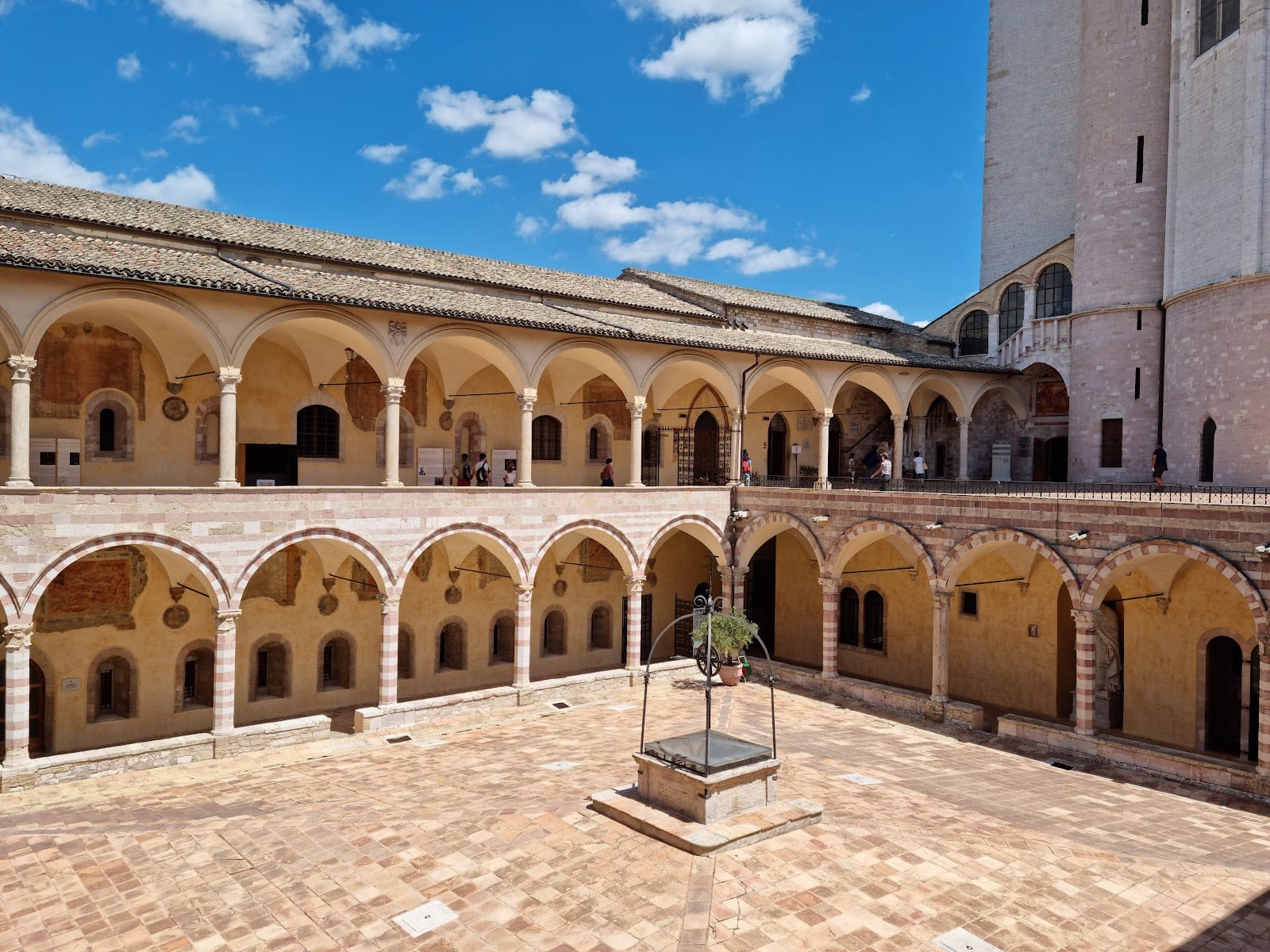 The arcaded cloister courtyard of the Basilica of St Francis of Assisi.