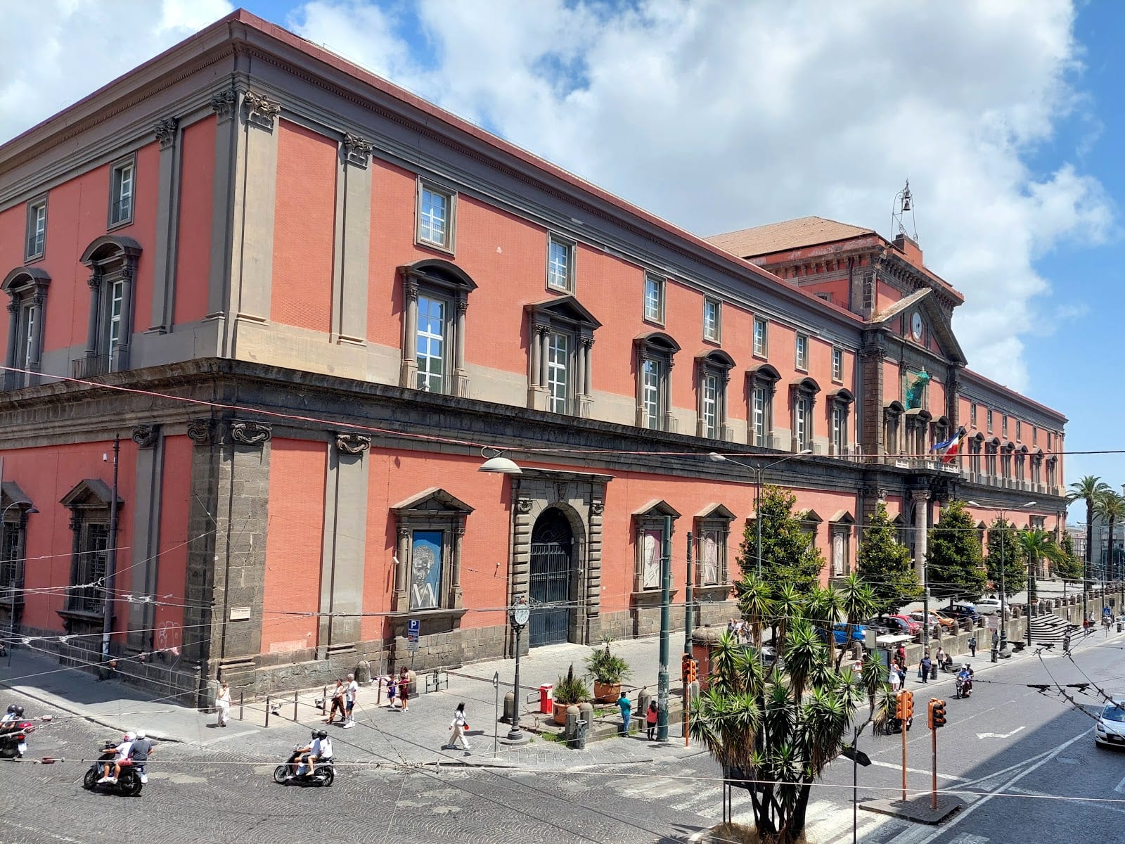 The red-ochre facade of the National Archaeological Museum of Naples.