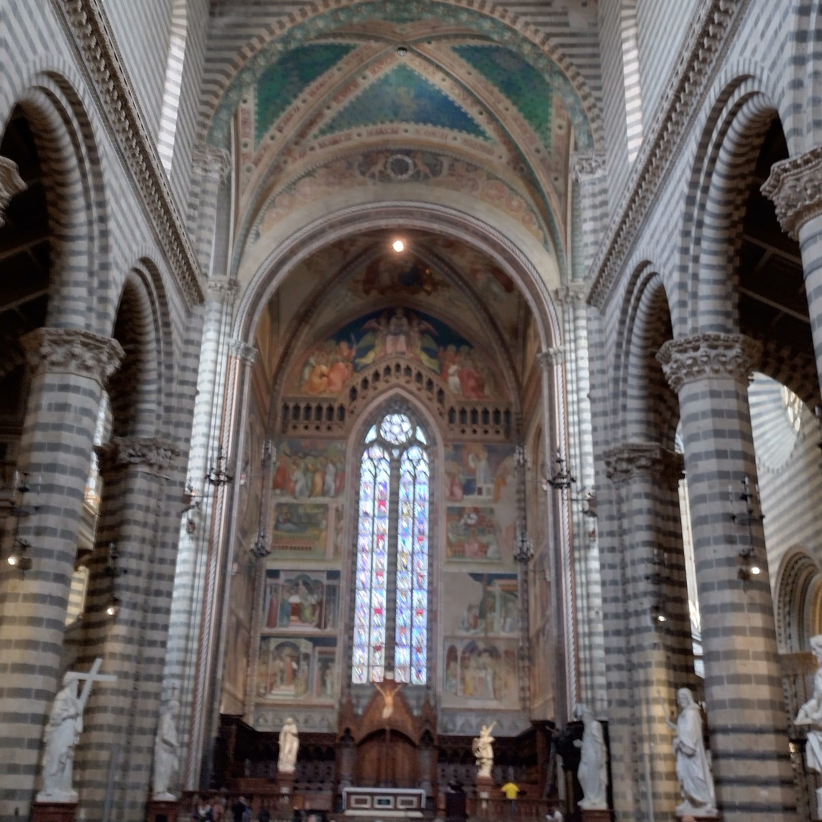 The striped interior of Orvieto Cathedral looking toward the apse.