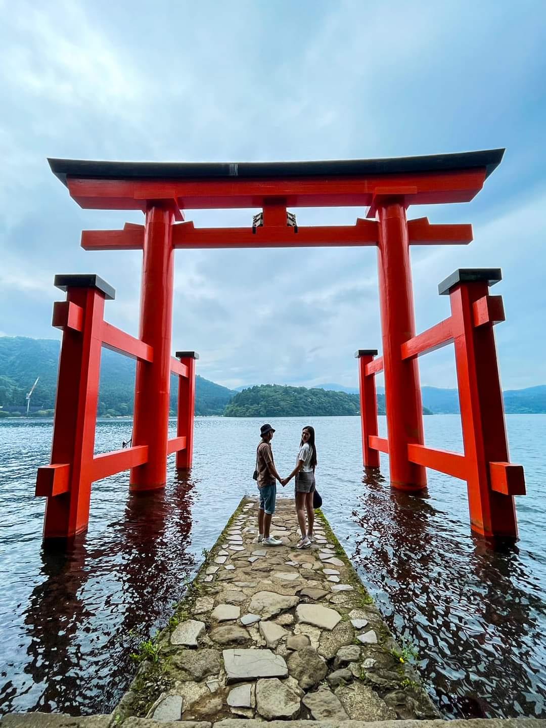 Mt. Fuji and the red Hakone Shrine torii beyond Lake Ashi.